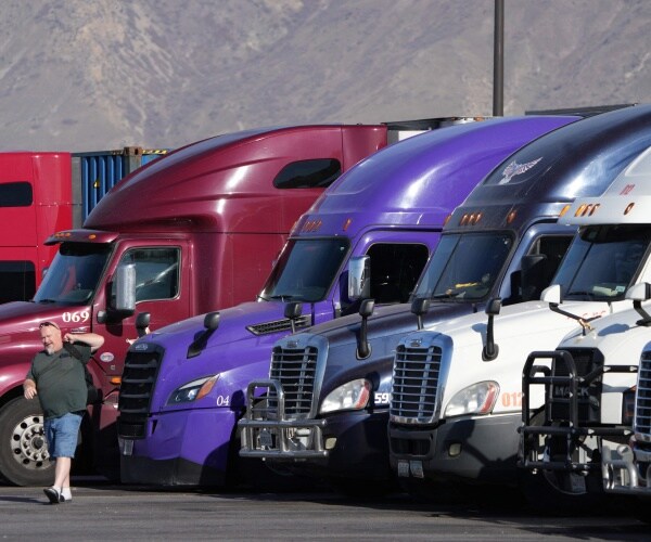 a line of trucks at a rest stop