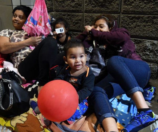 honduran migrants gather at a bus terminal, waiting for a second caravan to leave to the united states
