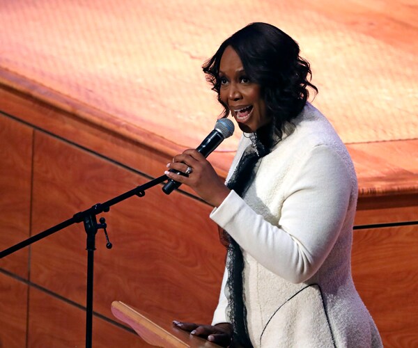 Maya Cummings speaks during her husband Elijah's funeral