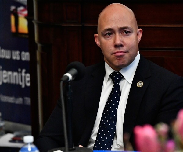 brian mast in a suit and navy blue polka dotted tie