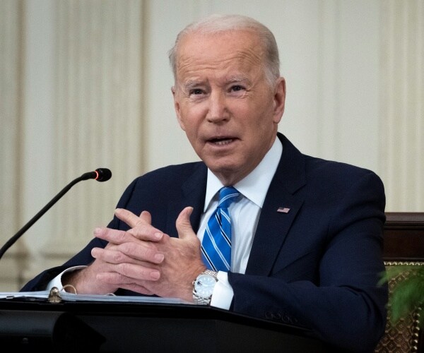 Joe Biden speaks into a microphone