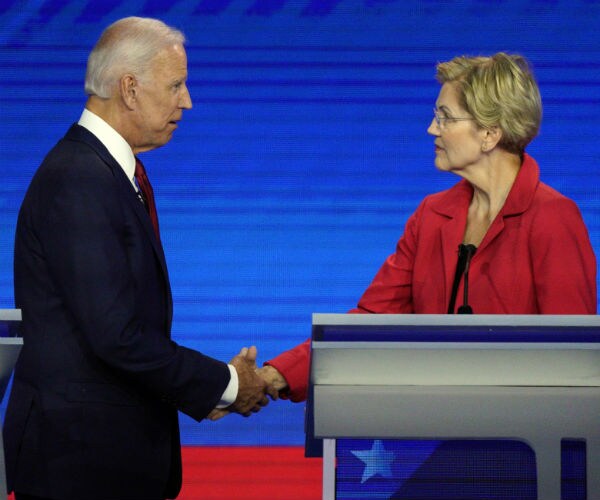 joe biden shakes sen. elizabeth warren's hand before a democratic debate