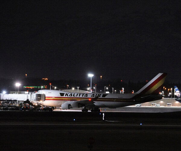 a plane carrying 240 American diplomats and citizens sits on the tarmac in anchorage, alaska