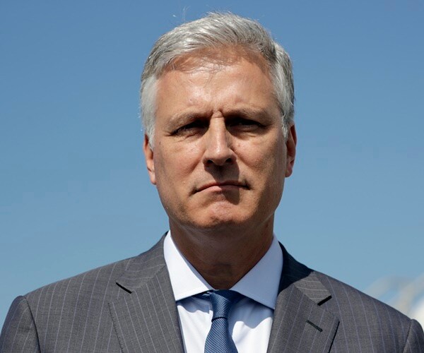 robert o'brien stands against a blue sky