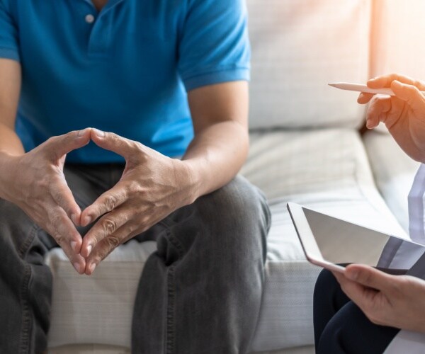doctor talking to man about prostate cancer in his office