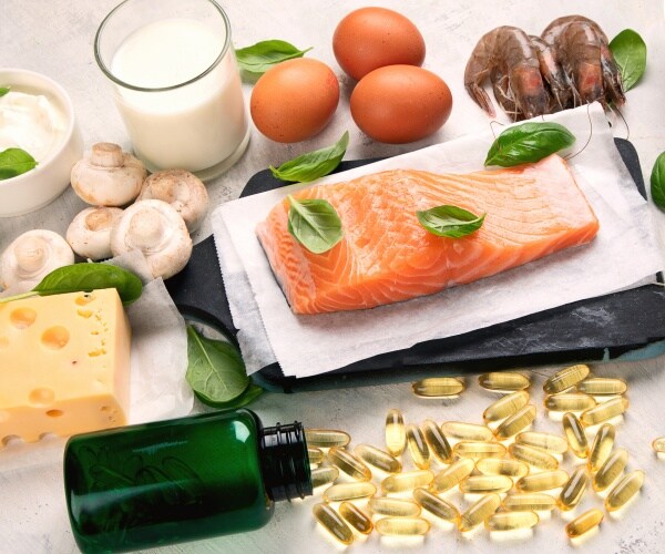 foods with vitamin d like fish cheese and milk are shown with supplement pills