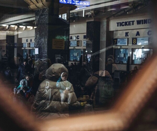 Several people wait inside the Kyiv station