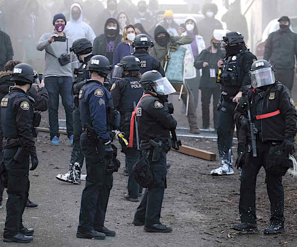 police in riot gear handle unruly protesters