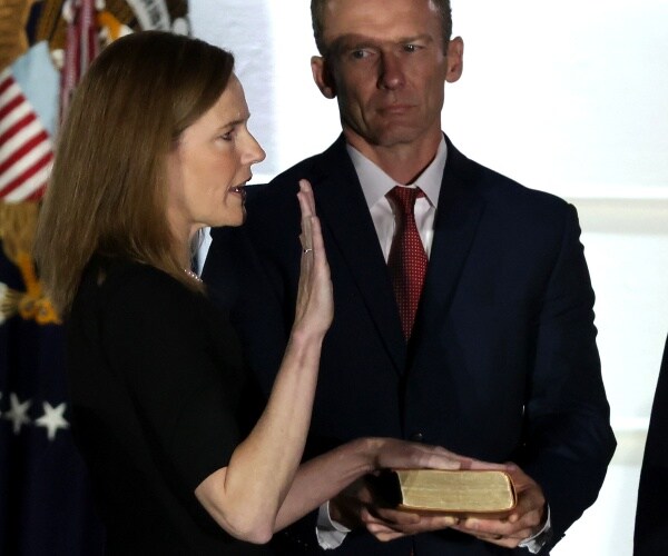 amy coney barrett has hand on bible