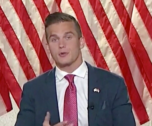 madison cawthorn speaks in front of flags