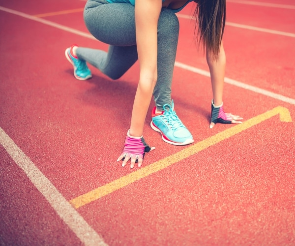 a track athlete gets ready to sprint