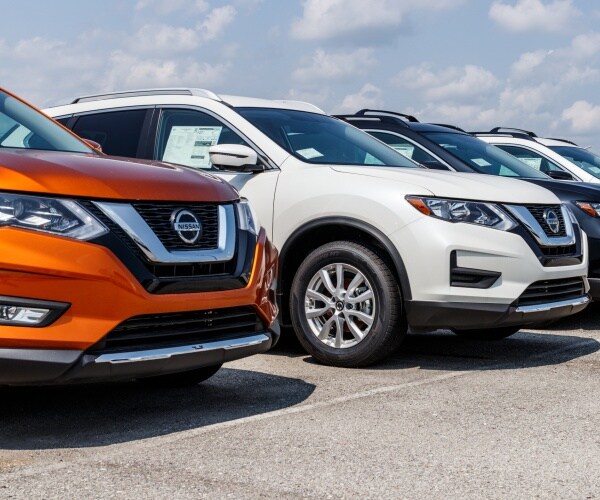 car dealership with nissan cars lined up in a row
