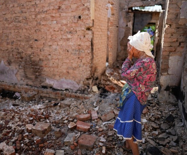 a woman holds her hands over her face