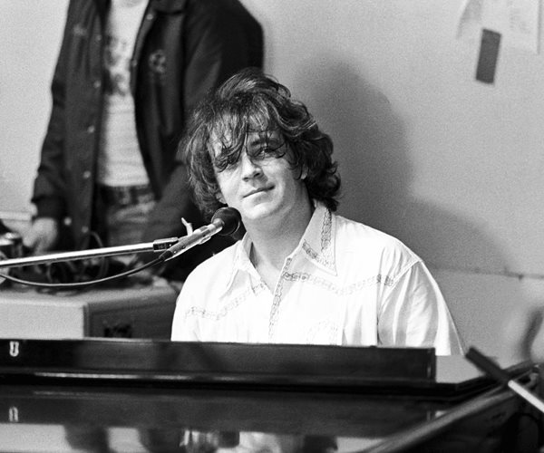 gary brooker pictured behind a piano in a black and white image from 1973