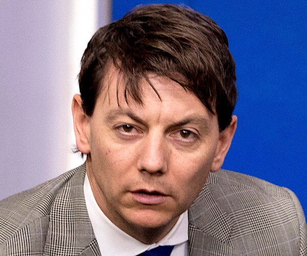 deputy press secretary hogan gidley looks up before a daily press briefing