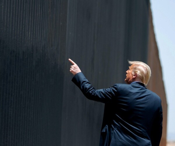 donald trump walking by the southern border wall