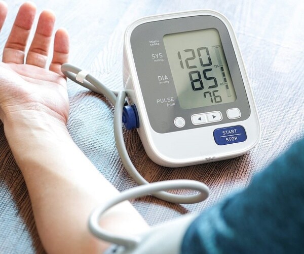 picture of person taking their blood pressure at home
