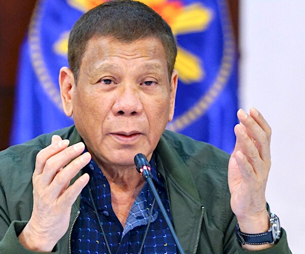 rodrigo duterte throws his hands up in objection during a news conference