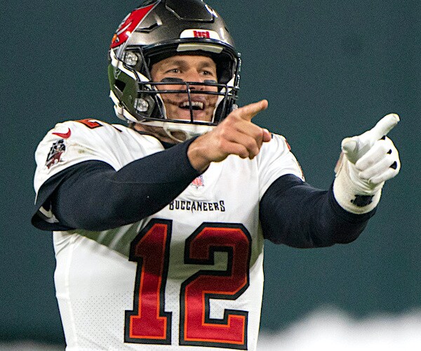 tom brady points and smiles during an nfl game