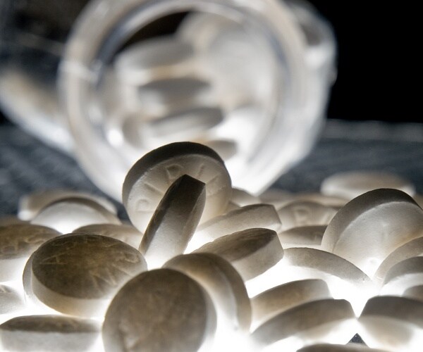 bottle of aspiring spilling onto table