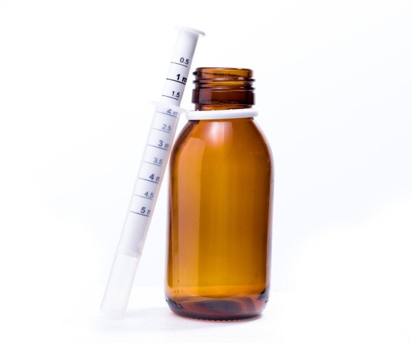 liquid children's antibiotics in a brown bottle and syringe