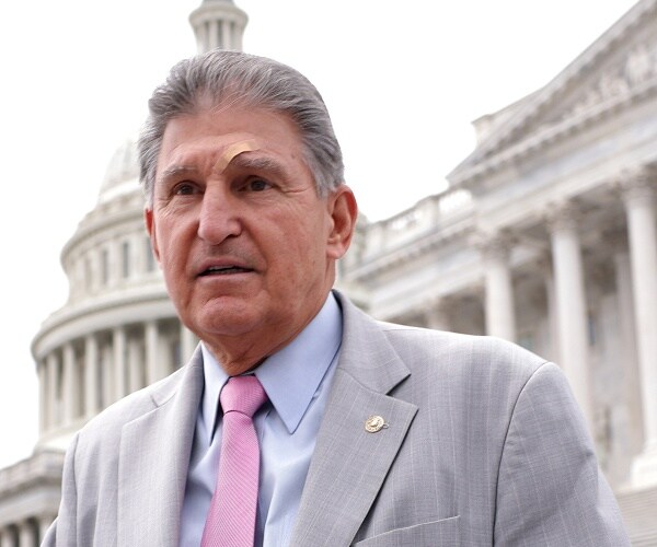 joe manchin walks down capitol steps