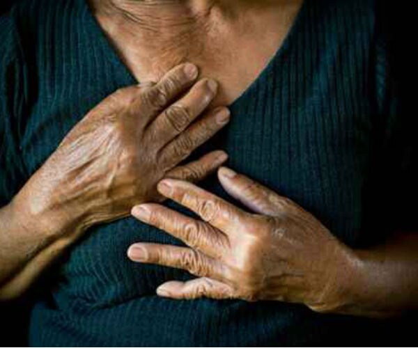 an older black woman clinching her chest