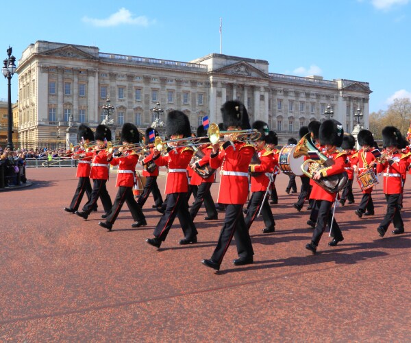 royal guards marching in formation in front of the palace