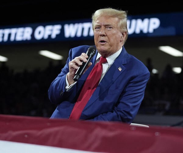 donald trump speaks into a microphone