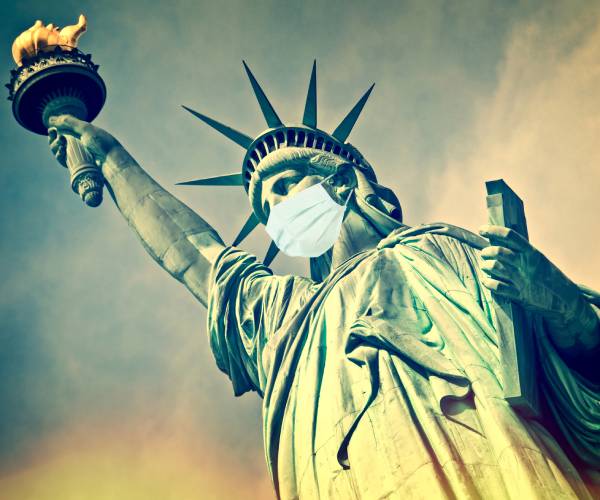 statue of liberty wearing a facemask