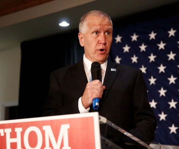 thom tillis speaks into microphone