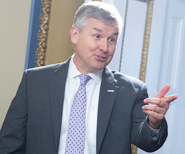 georgia republican rob woodall points with his left index finger, sticking his thumb up