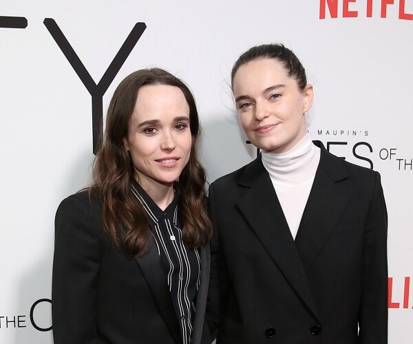 elliot page and emma portner stand on red carpet