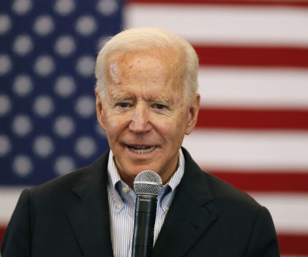 joe biden is shown with the american flag in the background