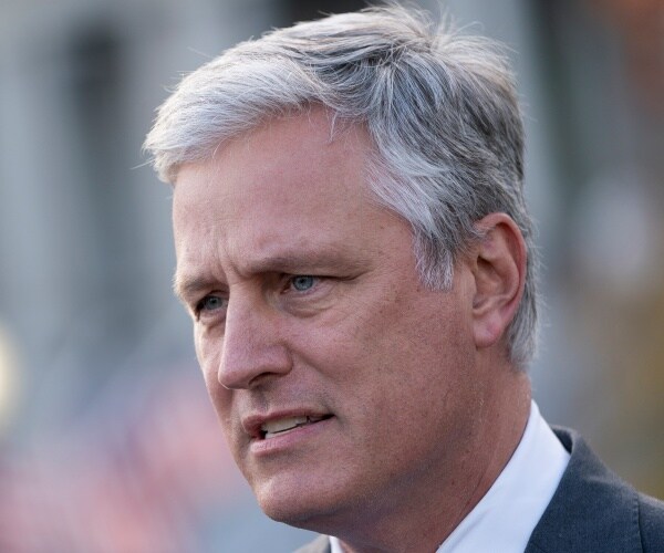 o'brien in a dark gray blazer and white dress shirt