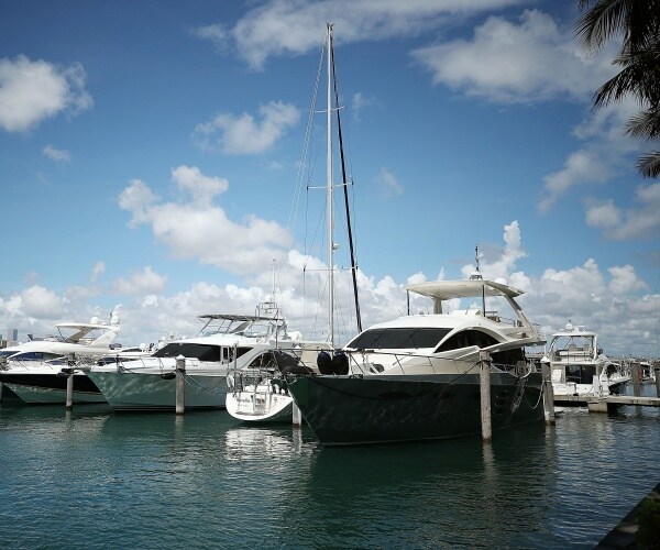 row of yachts are tied up in miami
