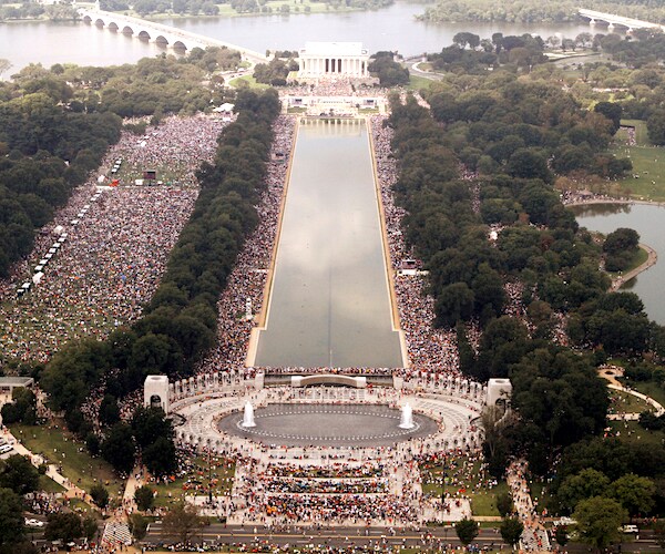 a packed crowd watches a ceremony at the lincoln memorial in washington, d.c.