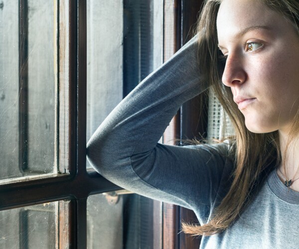 a teenage girl looking sad