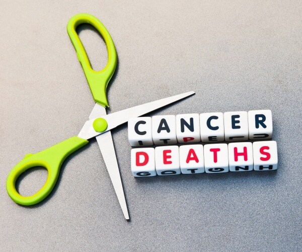 scissor open next to words 'cancer deaths' signifying cutting deaths from cancer
