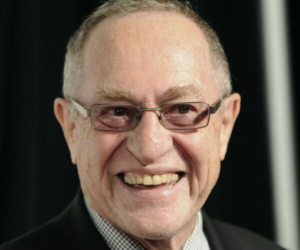 alan dershowitz smiles while speaking to reporters