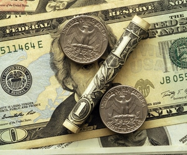 percent sign comprised of us dollar bills and coins