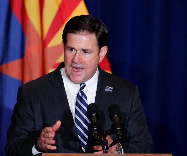 doug ducey speaks from behind podium