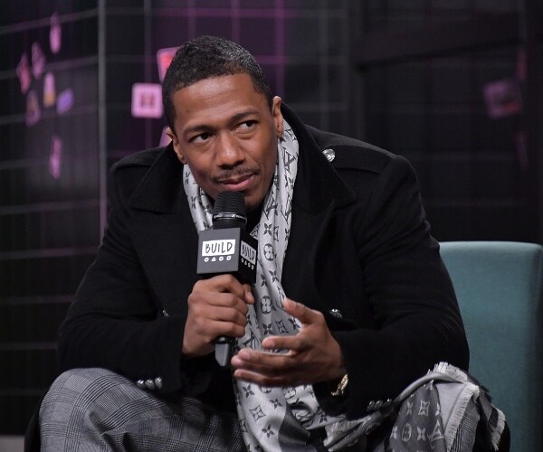 cannon in a black coat and louis vuitton scarf