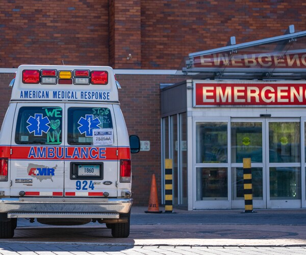 an ambulance sits outside an emergency room