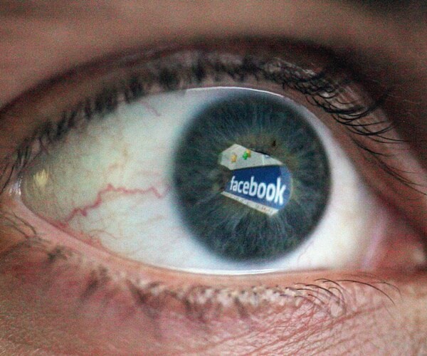 an eye reflect a facebook logo