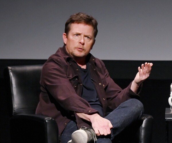 michael j fox sits onstage