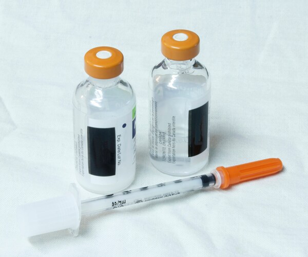 two insulin vials and a syringe