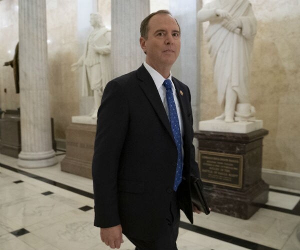 adam schiff is shown walking through capitol hill
