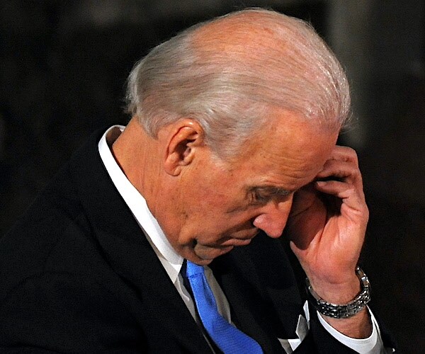 president joe biden scratches his bald, bowed head