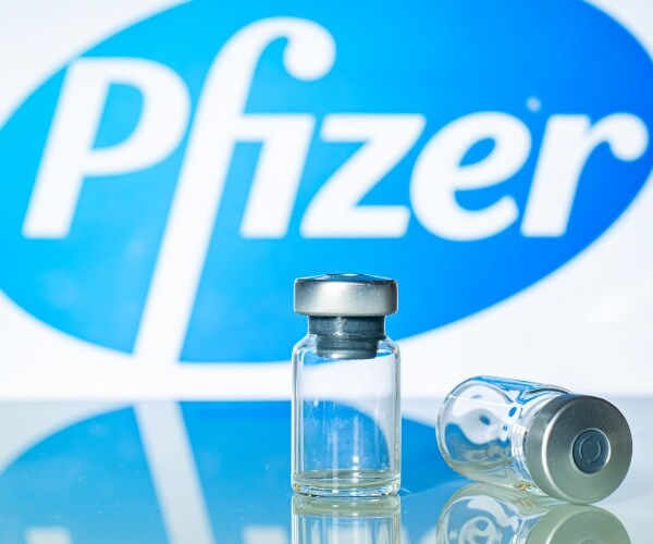 Pfizer logo, two vials in front of it